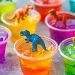 Colorful Dino Jello Cups with layers of vibrant jello and playful dinosaur figurines.