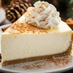 A rich, decadent eggnog cheesecake on a cake stand, ready to be served for the holidays.