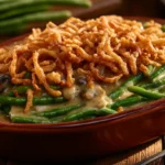 Classic green bean casserole with creamy texture and crispy fried onions on top.