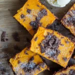 Fudgy sweet potato brownies with a perfect crumb, topped with a light sprinkle of cocoa.