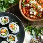 Colorful Terra Massoud sushi rolls with fresh fish, avocado, cucumber, and sesame seeds.