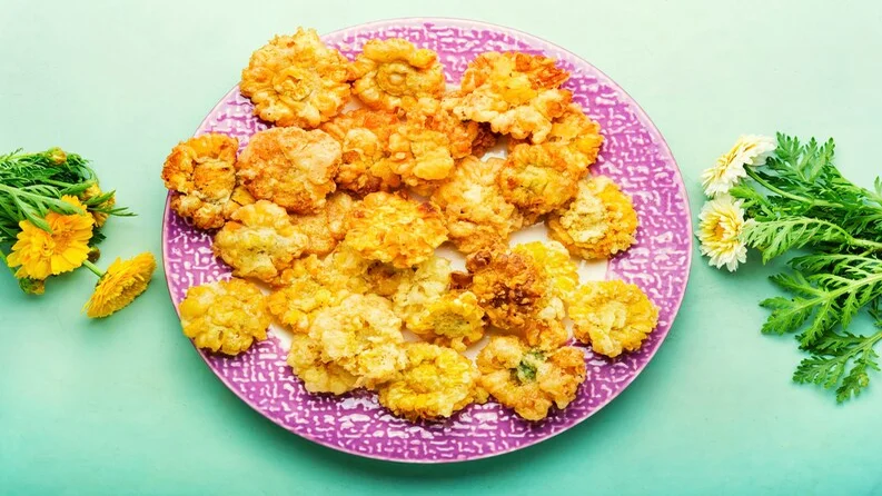 Homemade cauliflower crisps served with dip.